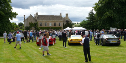 A photo of a house and cars, with people walking around A photo of a house and cars, with people walking around