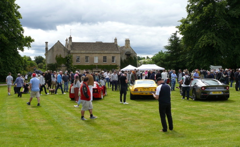 A photo of a house and cars, with people walking around A photo of a house and cars, with people walking around