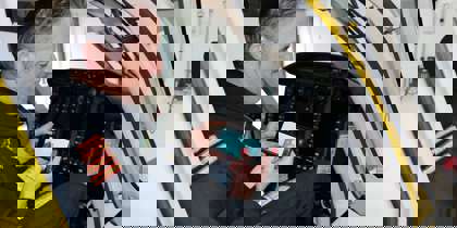 A pilot playing a helifun game on their phone inside the cockpit of the Bell-429 helicopter. A pilot playing a helifun game on their phone inside the cockpit of the Bell-429 helicopter.