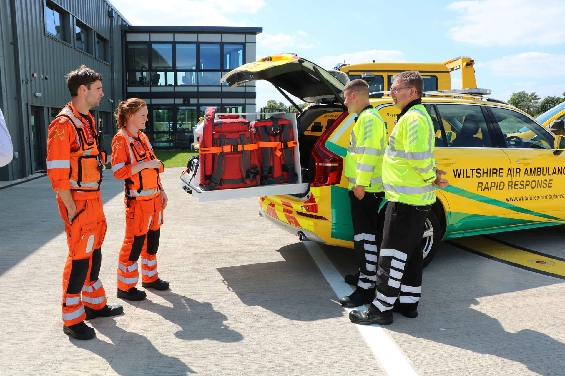 Two paramedics showing AA roadside recovery staff the equipment used in the critical care car.