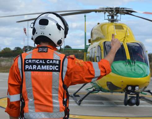 A paramedic giving a thumbs up to the pilot of the Bell-429 helicopter.