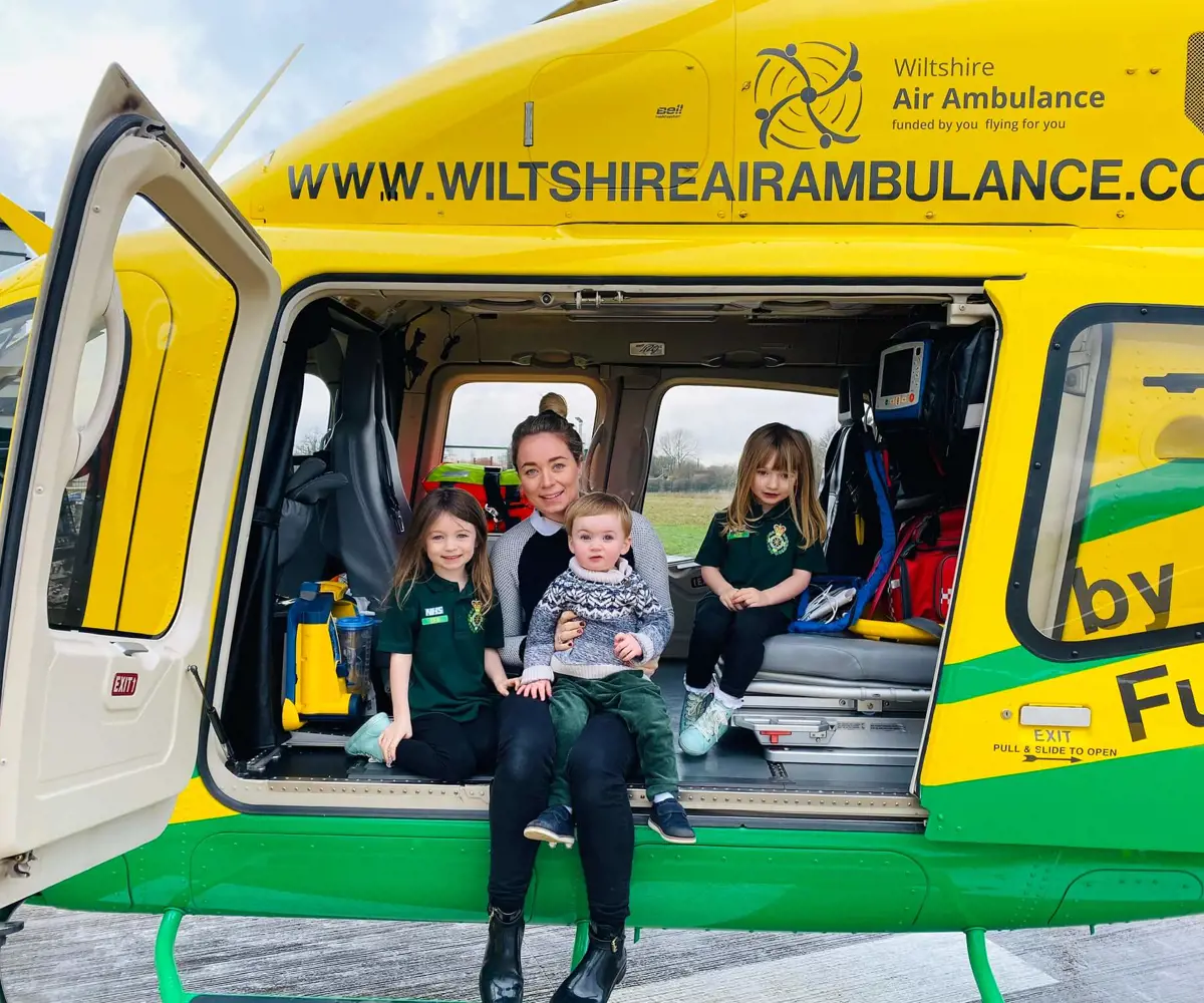 A family sat inside the Bell-429 helicopter on its helipad.
