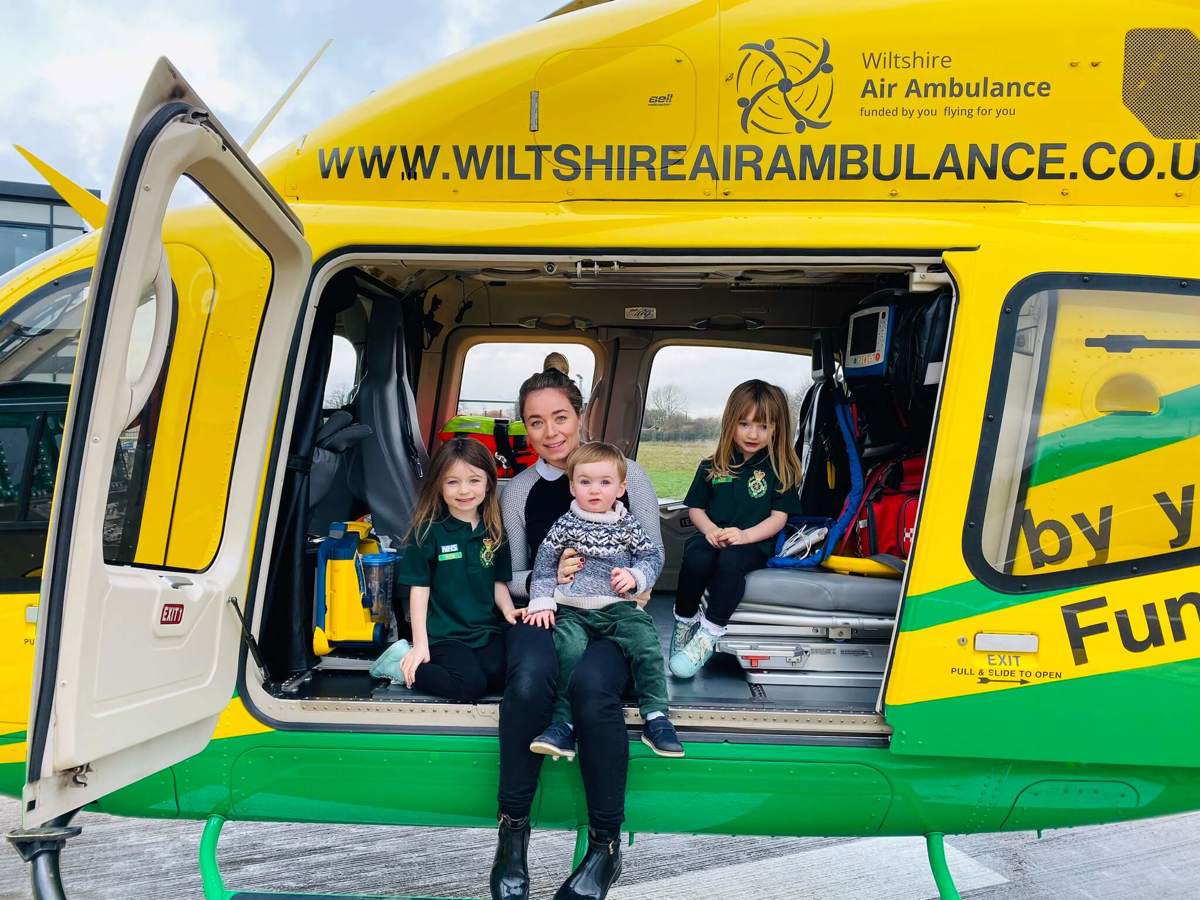 A family sat inside the Bell-429 helicopter on its helipad.