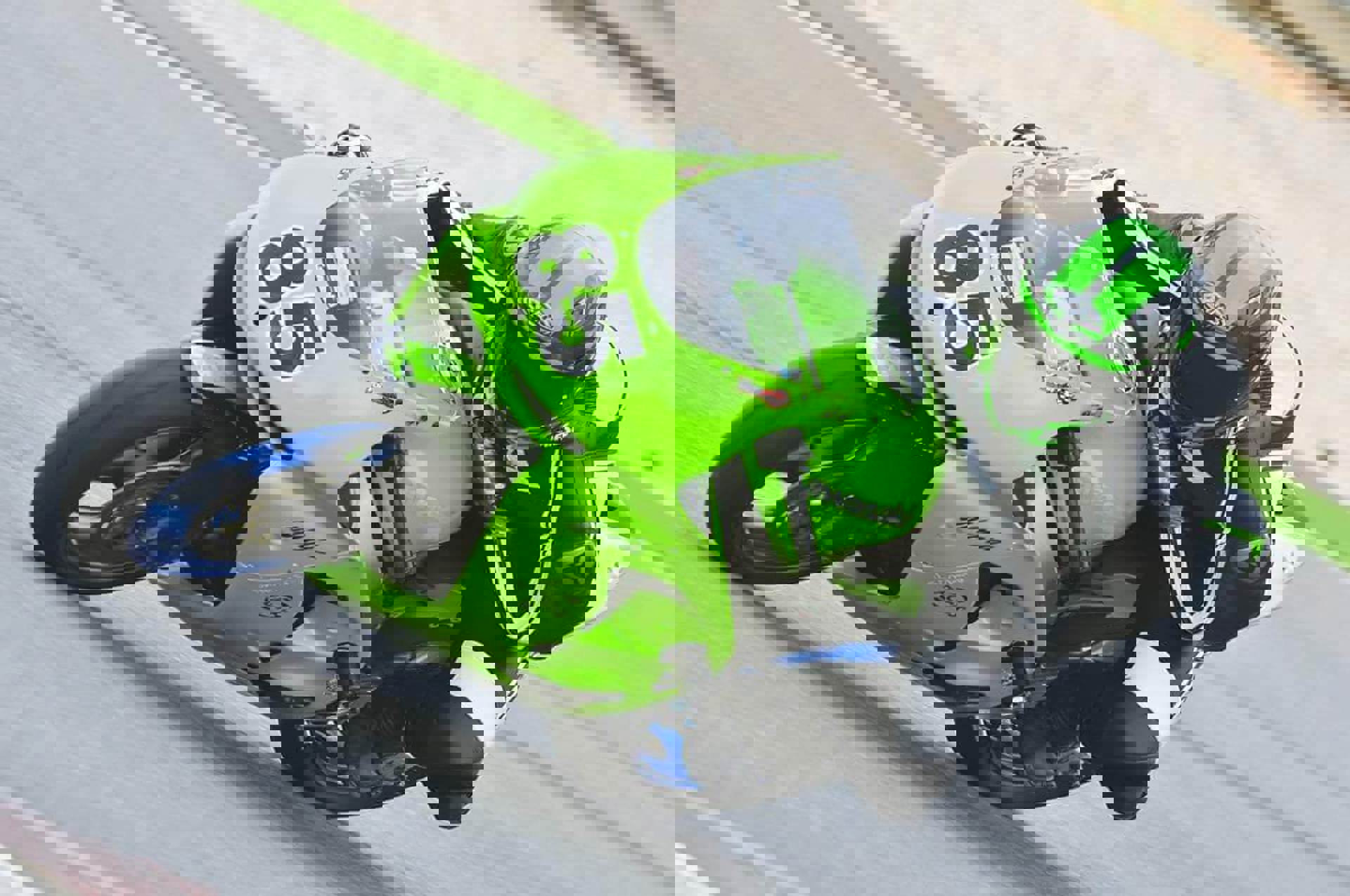 A motorcyclist on a green motorbike A motorcyclist on a green motorbike