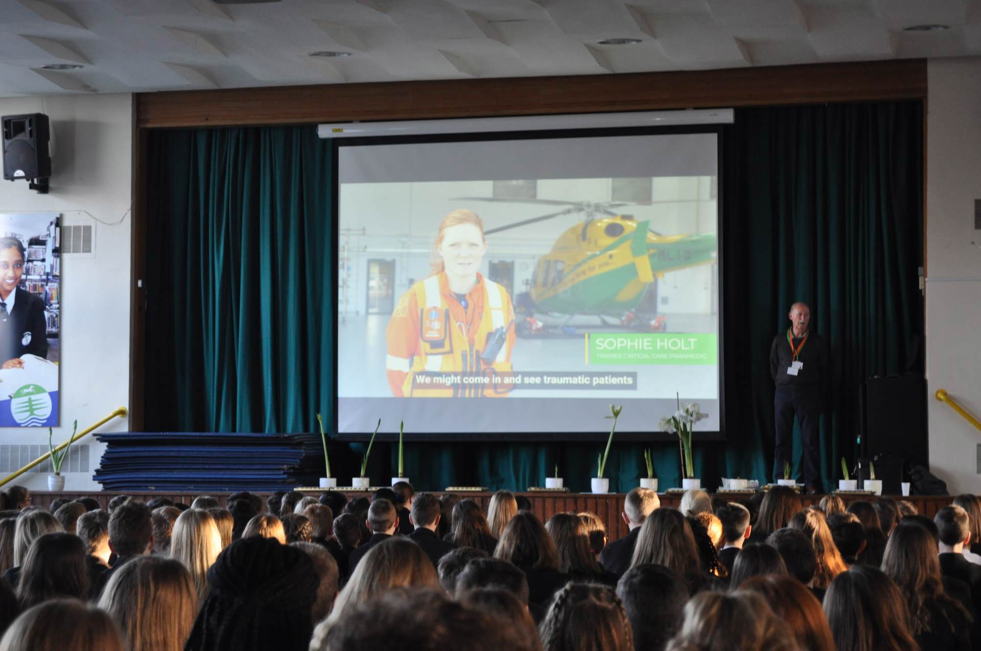 A volunteer delivering a talk at a school