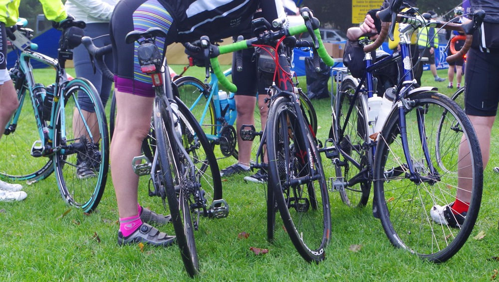 A photo of road bikes and cyclists at an event