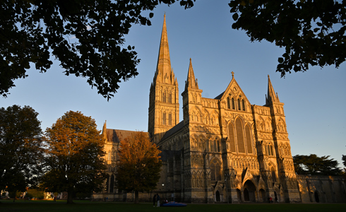 A photo of Salisbury cathedral with a sunset