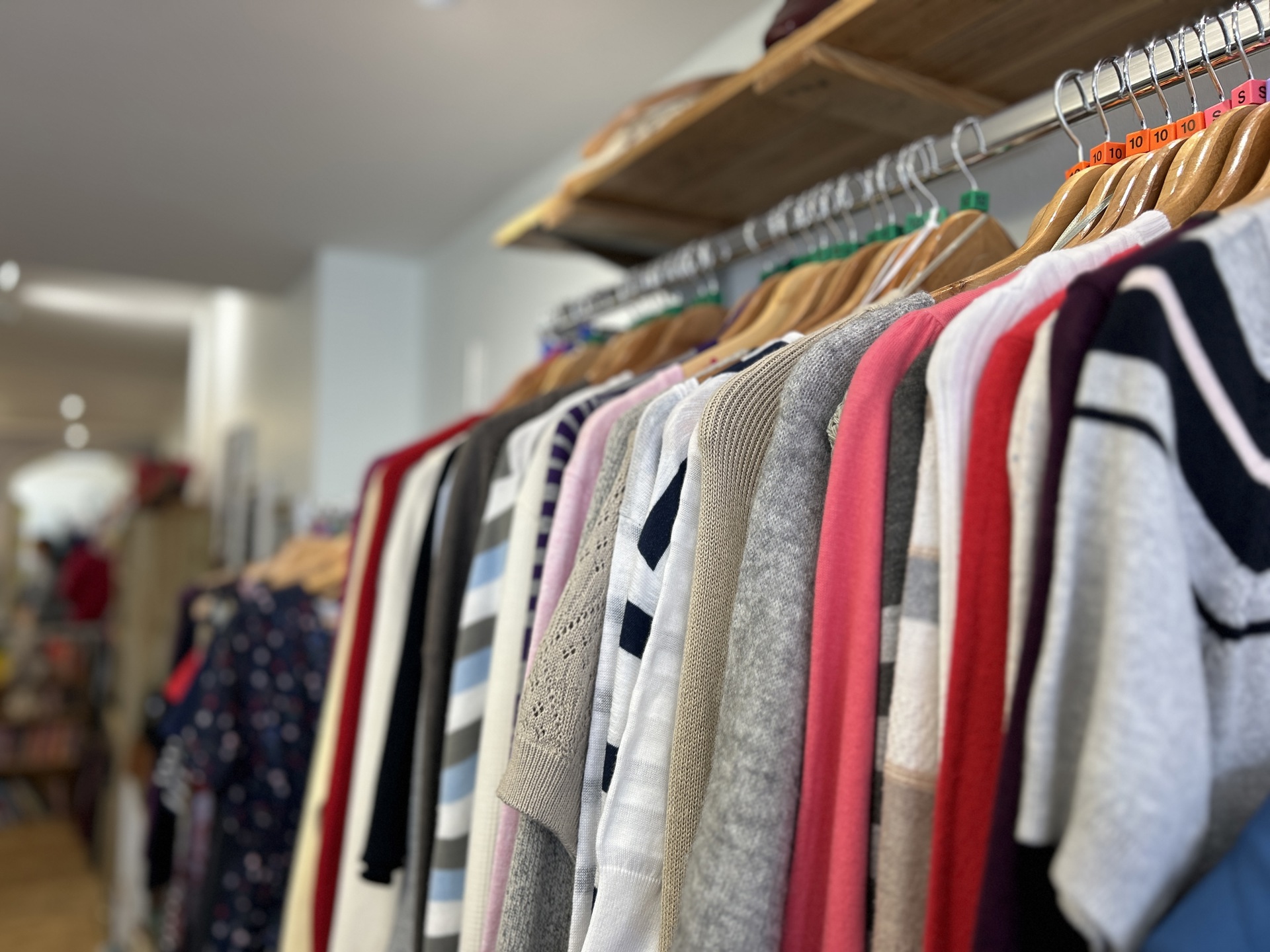 A rail of clothing for sale in the Devizes Charity Shop