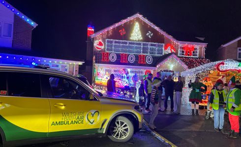 Yellow and green Wiltshire and Bath Air Ambulance critical care car at Sarum Avenue Christmas lights in Melksham