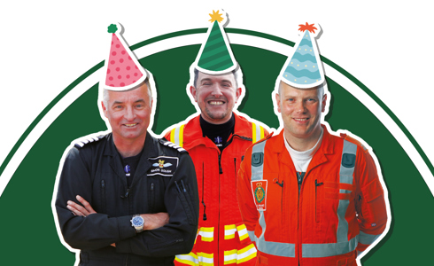A pilot, doctor and paramedic wearing flight suits with cartoon style party hat stickers on