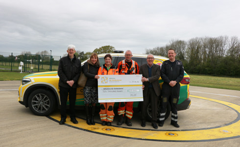 A cheque presentation from Malmesbury League Of Friends with WAA's crew, in front of their critical care car