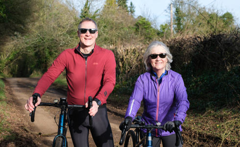 A photo of Nick and Gaynor Cole posing with bicycles