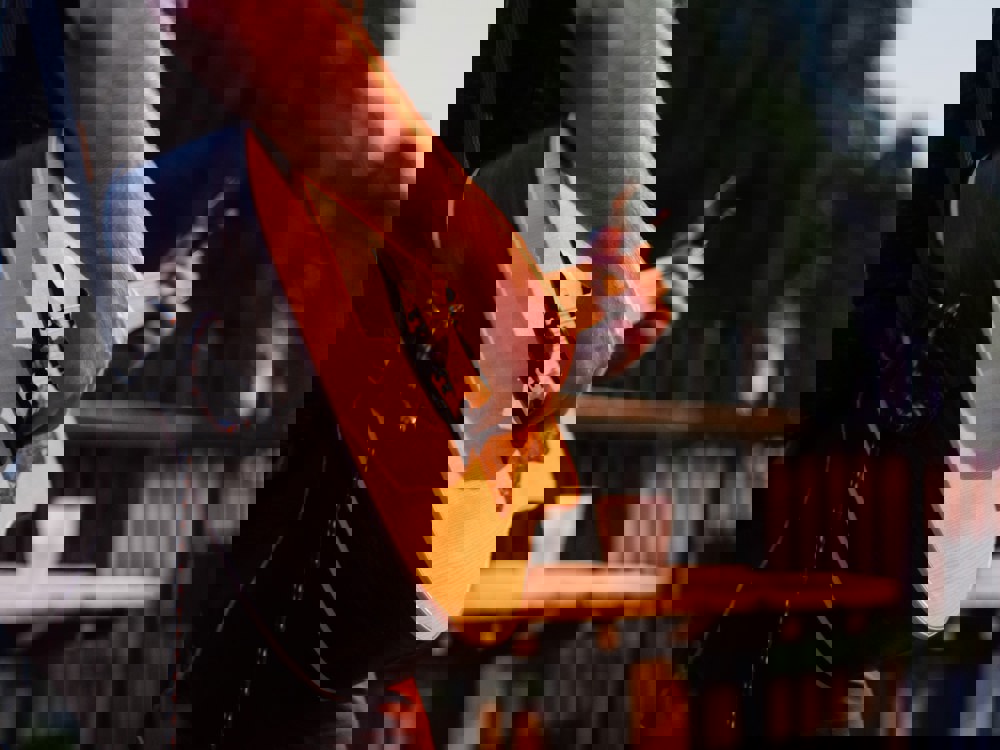 A person playing a guitar at an outdoor venue