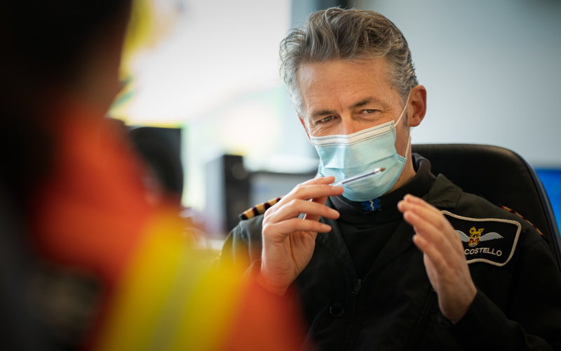 Pilot Elvis wearing a face mask and briefing crew