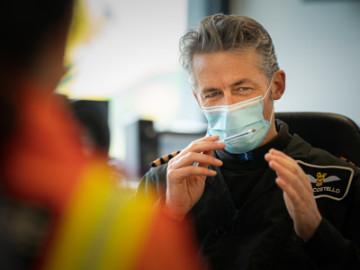 Pilot Elvis wearing a face mask and briefing crew Pilot Elvis wearing a face mask and briefing crew