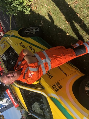 Critical care paramedic Keith Mills at Swindon Town Football Club in front of the charity's critical care car.