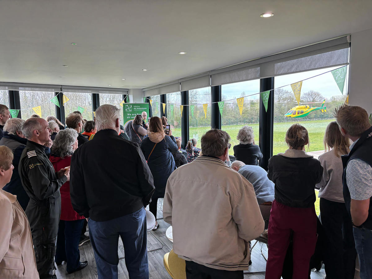 Visitors at WAA airbase viewing the helicopter taking off