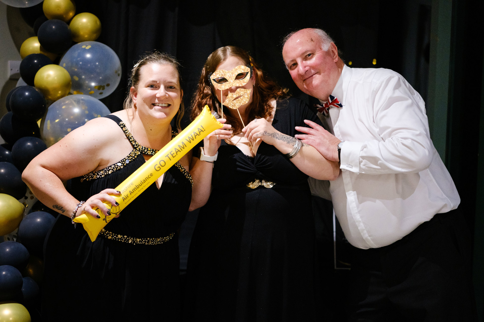 WAA ambassador Alan Dedicoat and charity ball attendees posing for a photo