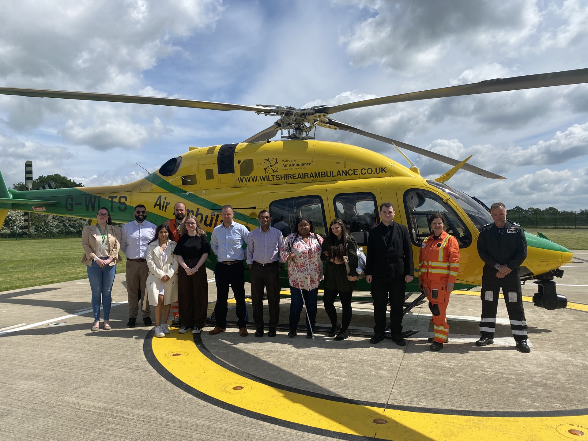 Staff from Halo Staffing in front of the WAA helicopter