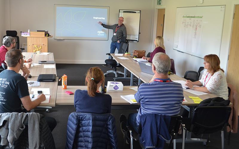 A group of people taking part in training in the Wiltshire Air Ambulance meeting room.