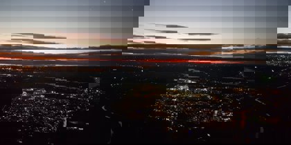 A photo of a town from above with a sunset