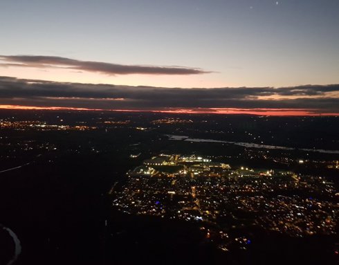 A photo of a town from above with a sunset