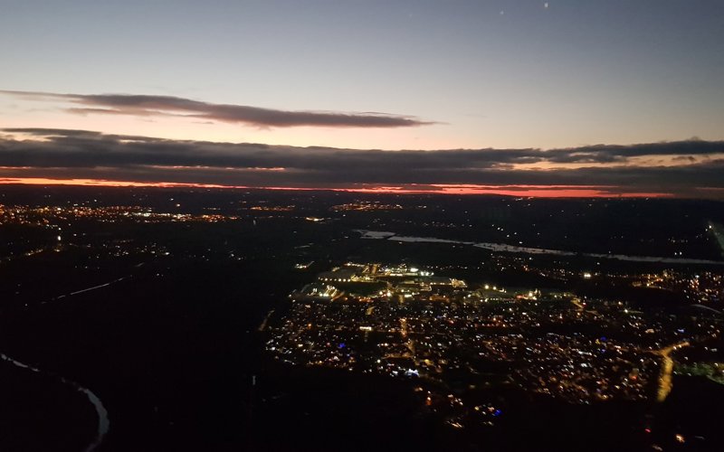 A photo of a town from above with a sunset