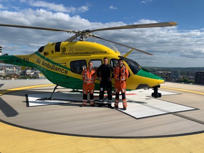 Paramedic Rich Miller, Pilot Rob Collingwood and Paramedic Adam Khan standing in front of the Wiltshire Air Ambulance helicopter on the BRI helipad Paramedic Rich Miller, Pilot Rob Collingwood and Paramedic Adam Khan standing in front of the Wiltshire Air Ambulance helicopter on the BRI helipad