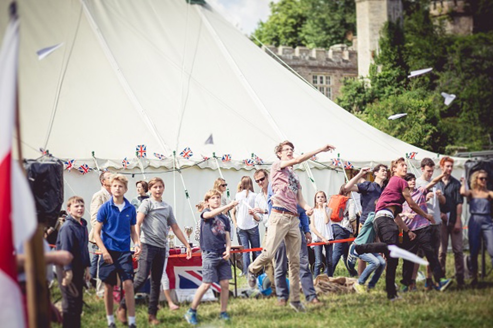 A group of people taking part in traditional games in front of a gazebo at a Teffont Village fete
