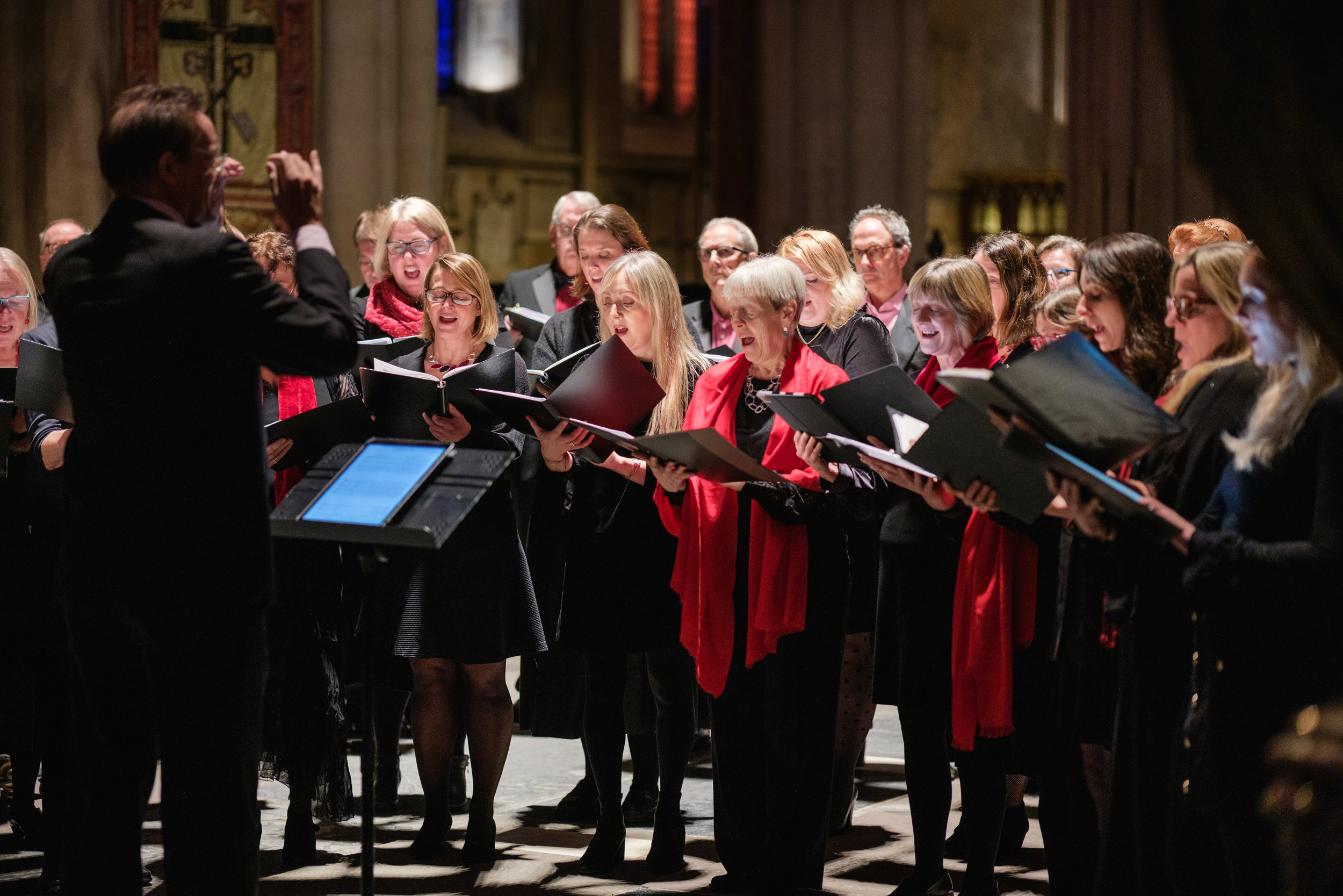 A choir singing with a conductor