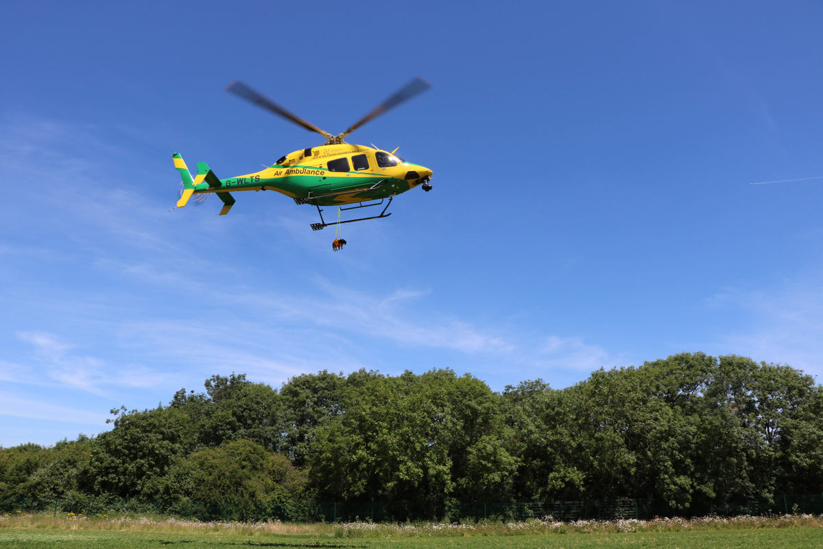 A photoshopped Dachshund dangling from the Wiltshire AIr Ambulance helicopter