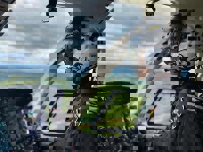 Pilot Rob wearing flight helmet, flying Wiltshire Air Ambulance's helicopter Pilot Rob wearing flight helmet, flying Wiltshire Air Ambulance's helicopter