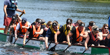 A team taking part in a boat race in aid of WAA