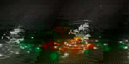 Wiltshire and Bath Air Ambulance Charity's new look helicopter on their helipad at night with the lights on Wiltshire and Bath Air Ambulance Charity's new look helicopter on their helipad at night with the lights on